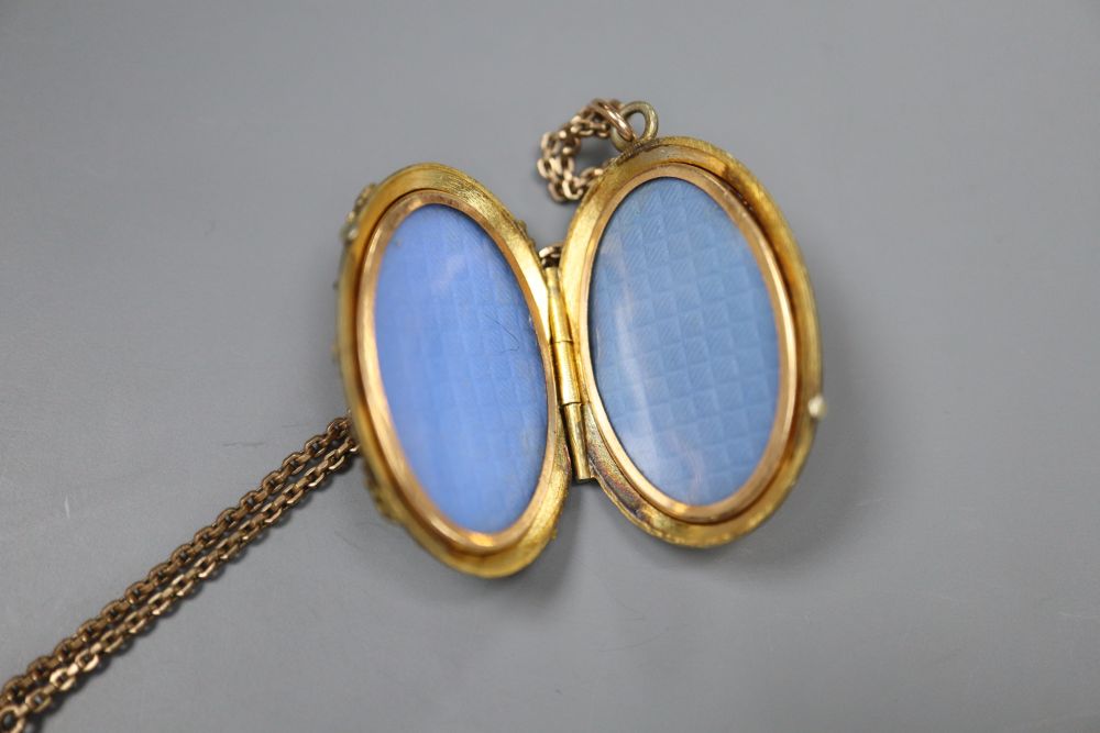 Two Victorian gilt metal brooches, a similar locket pendant on chain and a ladys silver cased wrist watch.